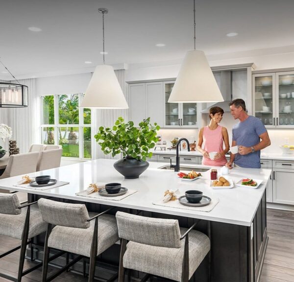 In-use lifestyle image of residents enjoying evening dining and conversation on the covered patio of the Valencia Bonita clubhouse overlooking the illuminated pool and lake, warm ambient lighting, photorealistic 8K, elegant and inviting atmosphere