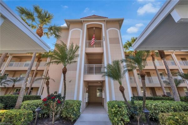 Photorealistic 8K alternative angle of the grand Mediterranean-style clubhouse at Cypress Woods Golf & Country Club at twilight, elegant exterior lighting highlighting architectural details, luxury cars in circular driveway, upscale country club ambiance, cinematic composition