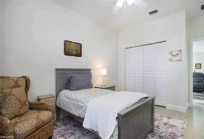 Bedroom featuring tile floors, a closet, and ceiling fan