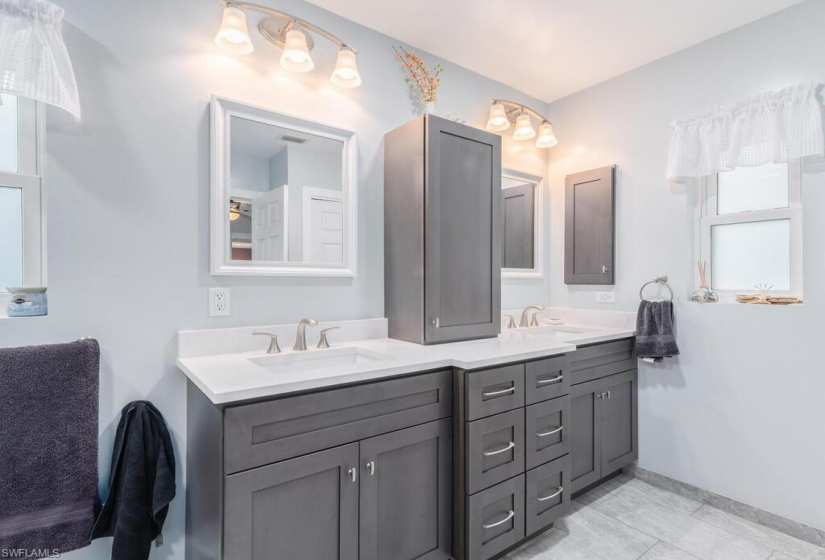 Bathroom featuring dual vanity and tile flooring