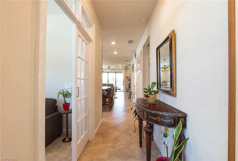Hallway with french doors and light tile floors