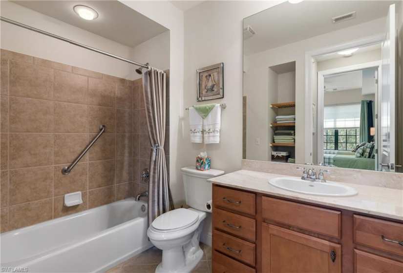 Full bathroom featuring toilet, tile floors, shower / tub combo, and oversized vanity