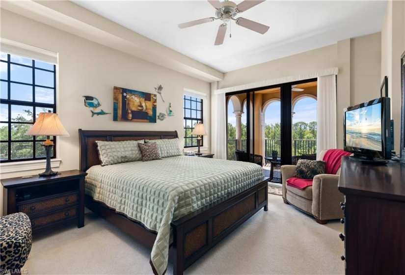 Carpeted bedroom featuring french doors, ceiling fan, and access to exterior