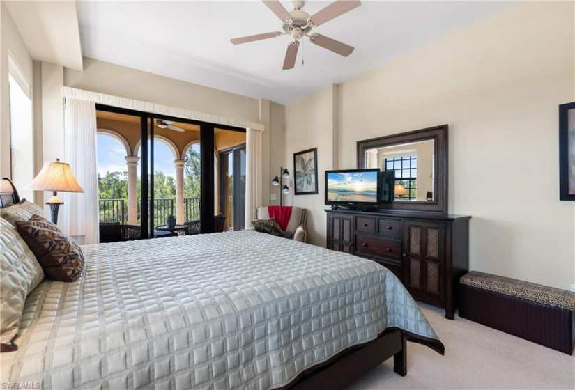 Bedroom featuring carpet flooring, ceiling fan, and access to exterior