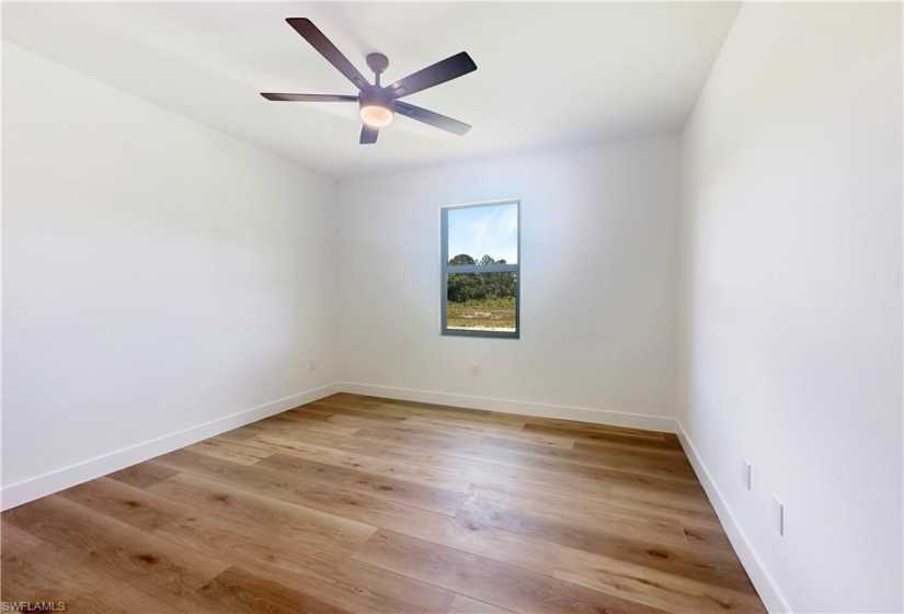 Empty room featuring ceiling fan and hardwood / wood-style floors