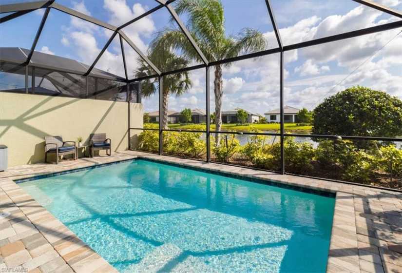 View of swimming pool with a patio and a lanai