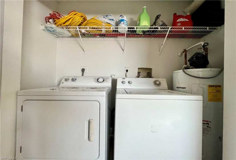 Clothes washing area with separate washer and dryer, washer hookup, hookup for an electric dryer, and water heater