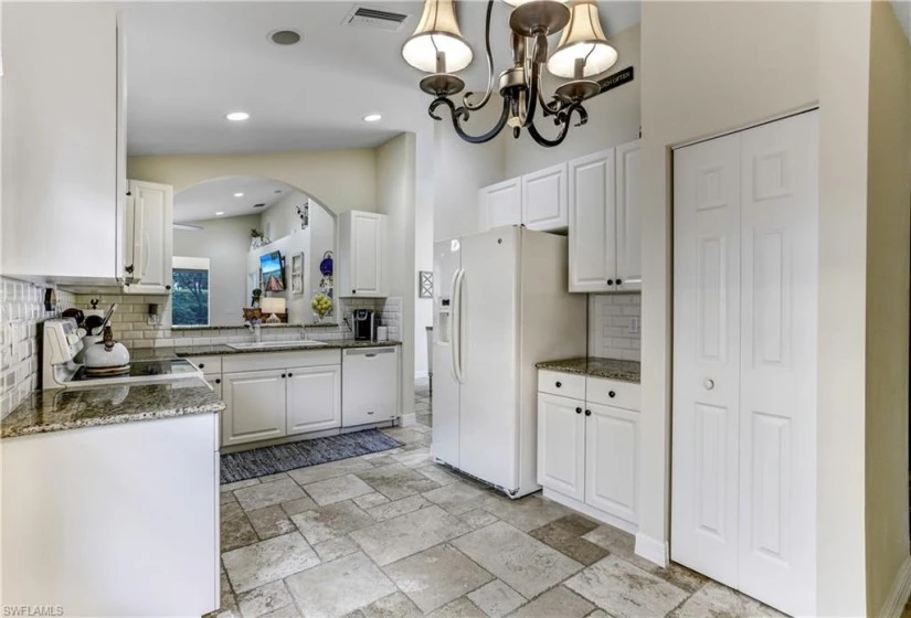 Large pantry, newer white refrigerator and dishwasher to match with the cabinetry.
