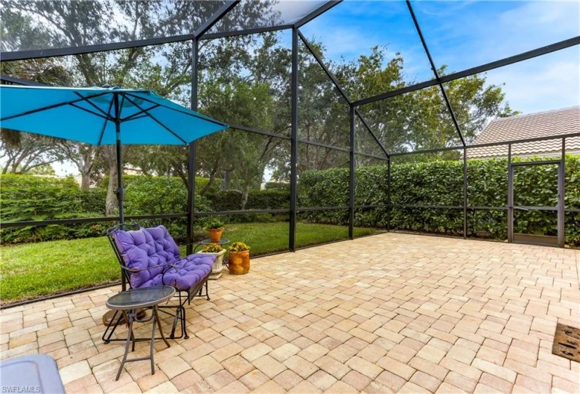 Southern Exposure, private, paver, spacious, screened lanai extension surrounded by Clusia hedges.
