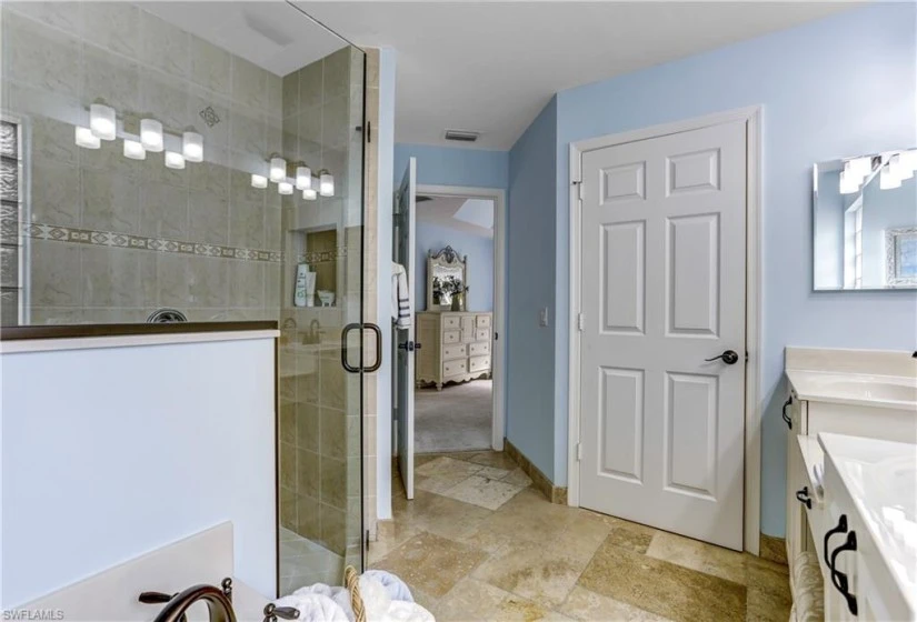 Tall vanities and large soaker tub. New lighting and plumbing fixtures.