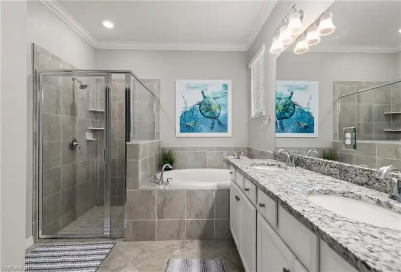 White cabinets, granite counters with under-mount duel sinks, separate tub and shower and a water closet grace this spacious master bath.