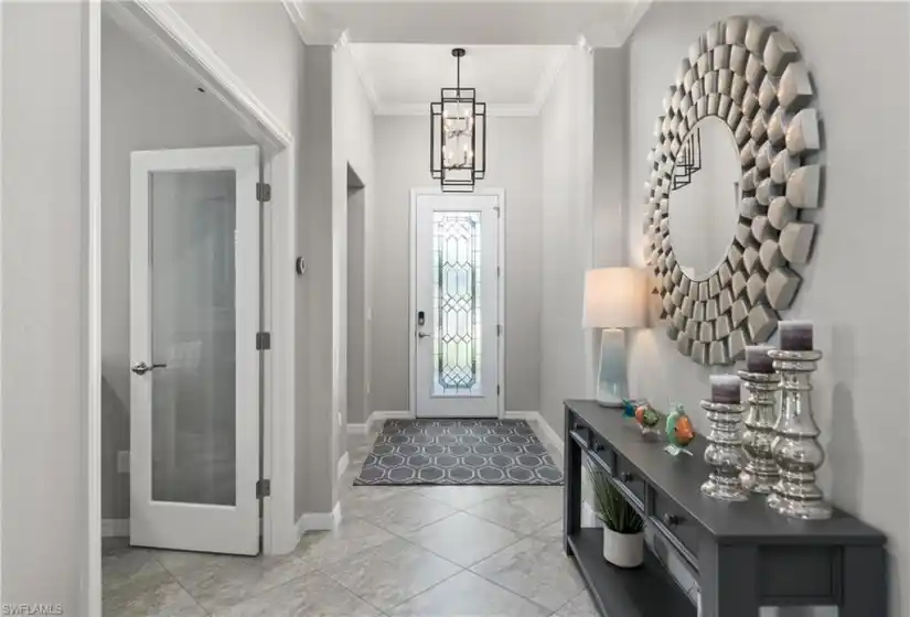 The foyer boasts a newly installed modern chandelier. Tile throughout the entire home makes cleaning a breeze.