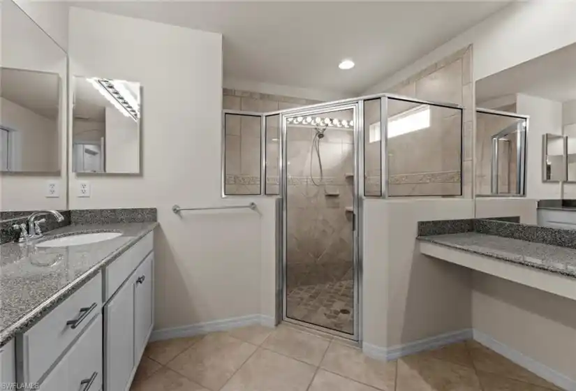 Large step-in shower and makeup vanity to right