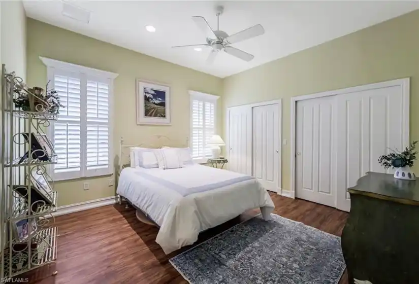 Guest bedroom #1 with lovely plantation shutter and molding windows and great closet space!