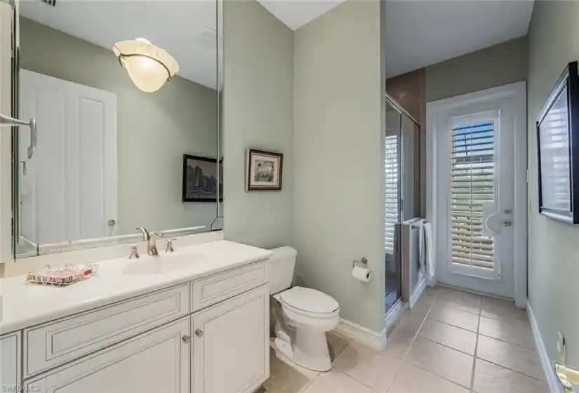 Guest / Pool Bath with walk-in shower and plantation shutter door!