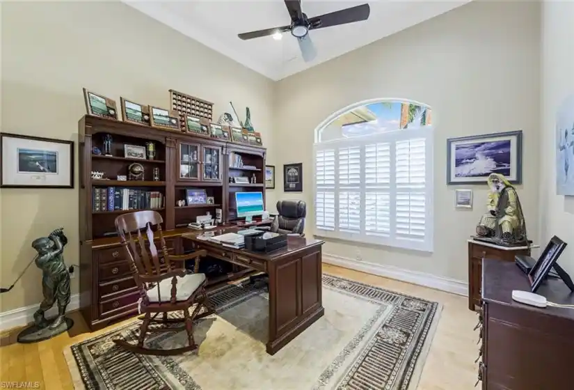 Den / Office with lovely natural light, plantation shutters, recessed lights and ceiling fan!