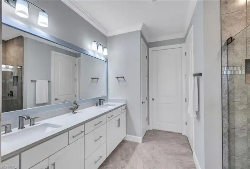 Dual sinks, walk-in shower with upgraded glass door and tiled to ceiling.  Trim work.