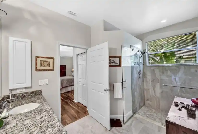 Updated primary bathroom features a large walk-in shower.