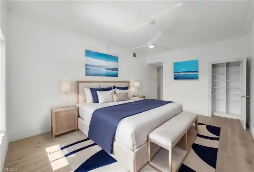 Virtually Staged Primary Bedroom with eastern views of Venetian Bay.