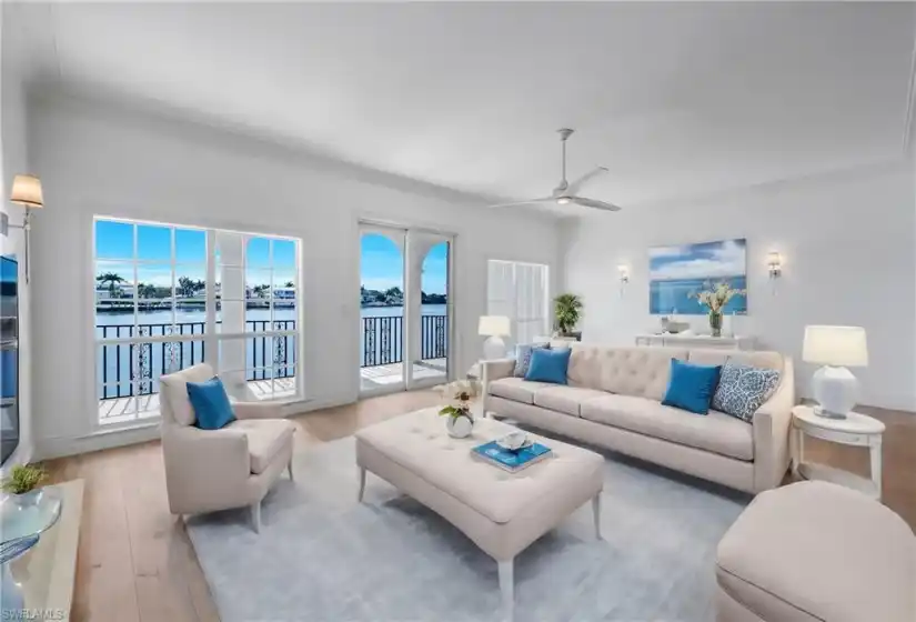 Virtually staged Great Room with hardwood floors and eastern view of Venetian Bay.