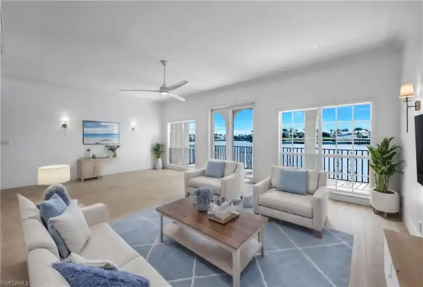 Virtually staged Great Room with hardwood floors and eastern view of Venetian Bay.