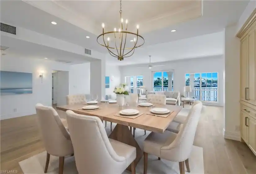 Virtually staged Dining Area/Great Room with hardwood floors and eastern view of Venetian Bay.