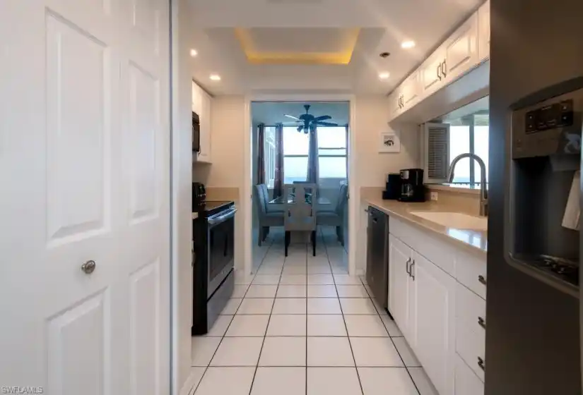 Well equipped kitchen with the laundry area behind the folding doors.
