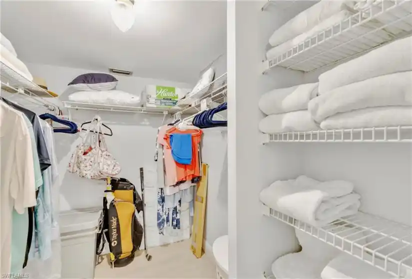 Large primary closet with ample shelving