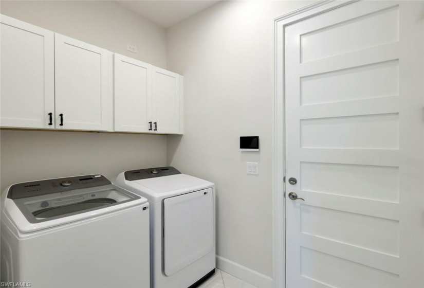 Laundry with add'l storage cabinetry.