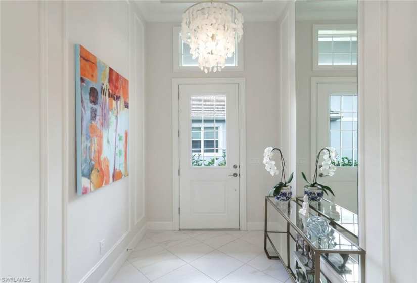 Grand front entry with decorative molding detail and Capiz chandelier.