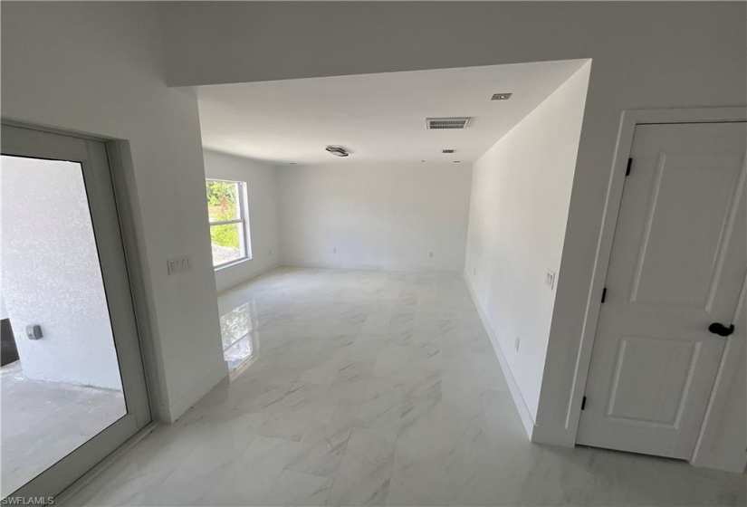 Spare room with light tile floors