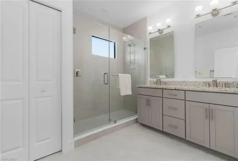 Dual Sinks w/ Linen Closet and Glass Enclosed Shower